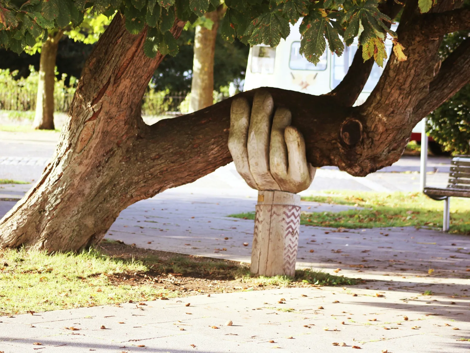 a tree with a statue of a person on it