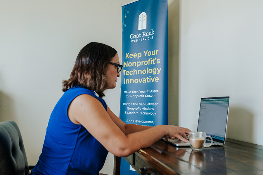 Lisa, CEO of Coat Rack Web Services, sitting at her desk working.