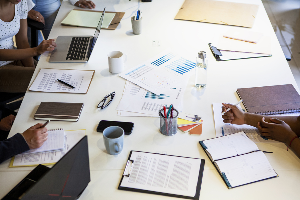 High angle view of boardroom table with coworkers 
